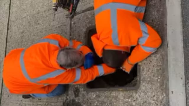 Image showing installation of a UDlive sensor in a manhole