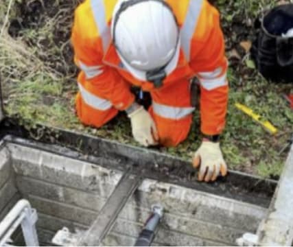 Image showing installer inspecting installation of a UDlive device.