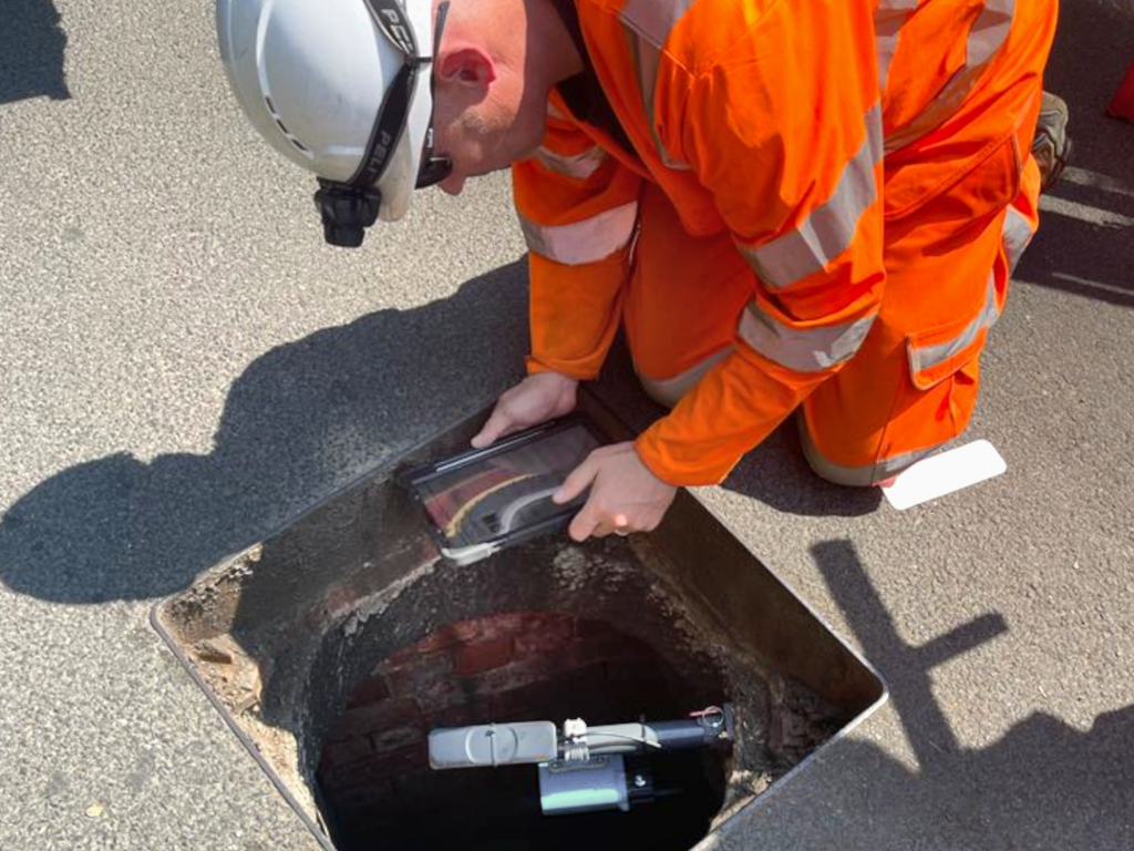 Installer inspecting site and UDlive sensor device.